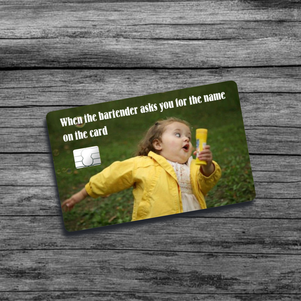 A credit card skin featuring the running girl blowing bubbles meme: a young girl in a yellow jacket with a surprised expression, mid-run holding a bubble wand.