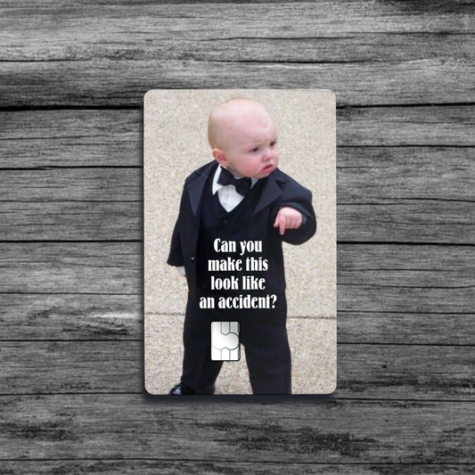 A credit card skin featuring the Baby Godfather meme: a baby in a suit and tie, pointing with a serious expression, as if giving orders.