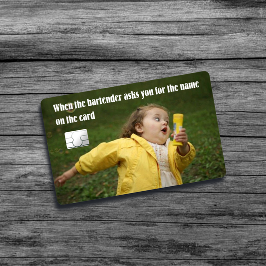 A credit card skin featuring the running girl blowing bubbles meme: a young girl in a yellow jacket with a surprised expression, mid-run holding a bubble wand.