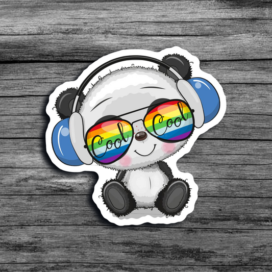 A sticker of a baby panda sitting, wearing rainbow sunglasses that say "Cool" and blue headphones, with a cute smile