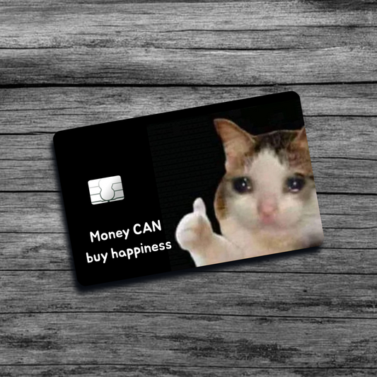 A credit card skin featuring the Crying Cat Thumbs Up meme: a cat with teary eyes, holding a thumbs up gesture, set against a black background.