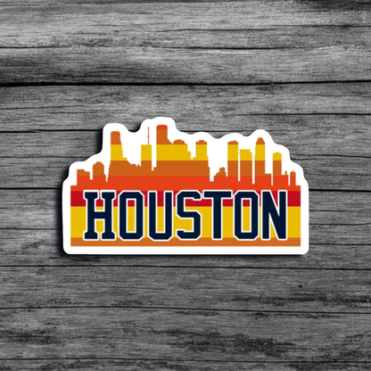 A sticker of the Houston, TX city skyline, with an orange and yellow color scheme, with the word "Houston"