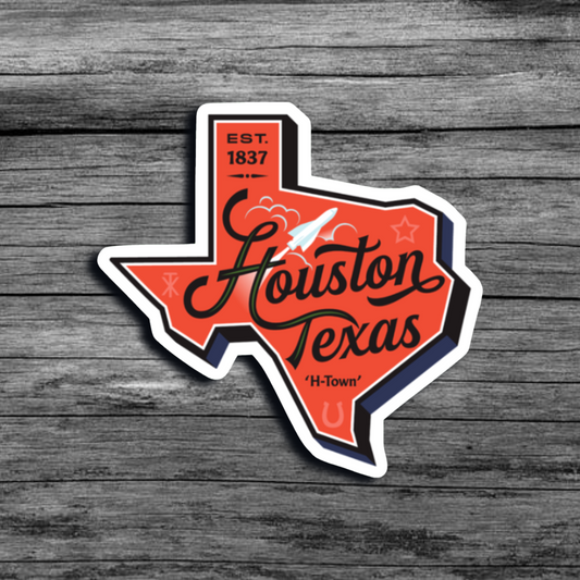 An orange sticker in the shape of the state of Texas, that says "Est. 1837 Houston Texas 'H-Town'"