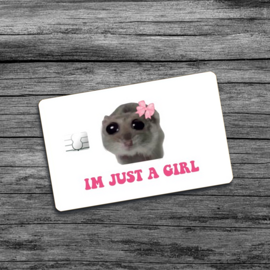 A credit card skin featuring the I'm Just A Girl meme: a hamster with a pink bow and wide beady eyes, set against a white background.