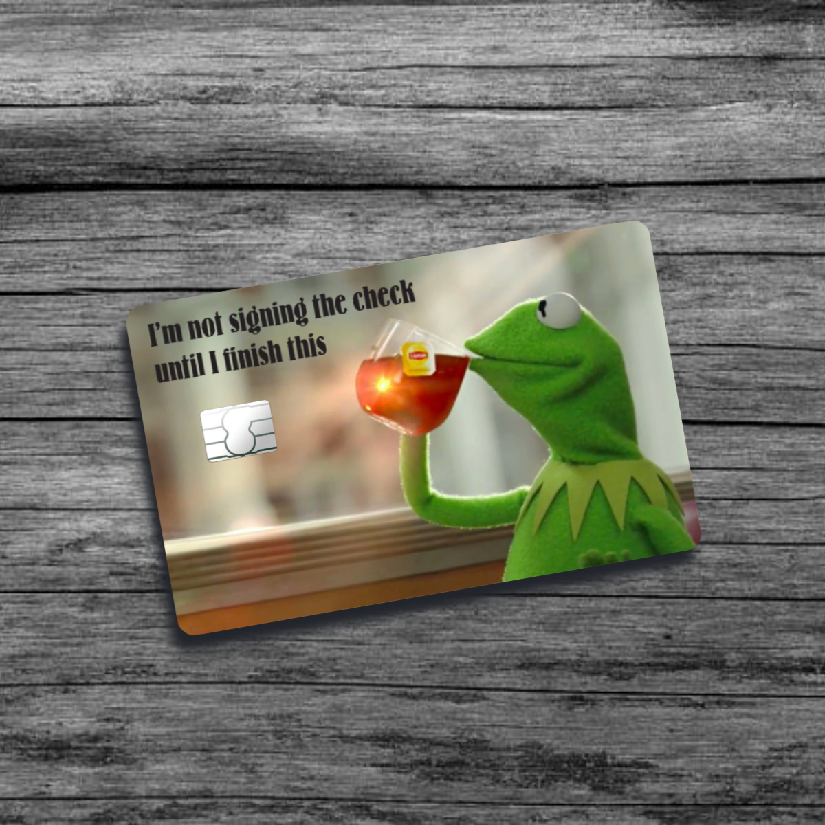 A credit card skin featuring Kermit the Frog sipping tea with a relaxed expression, capturing the iconic "but that's none of my business" meme moment.