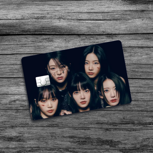 A credit card skin featuring K-Pop group Le Sserafim, five women's faces with black hair and light face makeup, set against a black background.