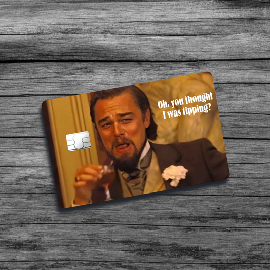 A credit card skin featuring Leonardo DiCaprio's character from Django Unchained, mid-laugh with a glass, capturing a moment of excitement and celebration.