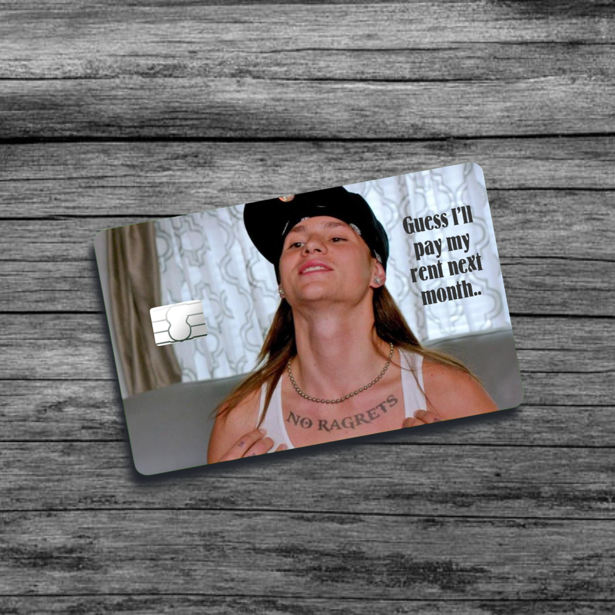 A credit card skin featuring the "No Ragrets" meme: a tattooed man with a serious expression, showcasing the misspelled tattoo on his chest.