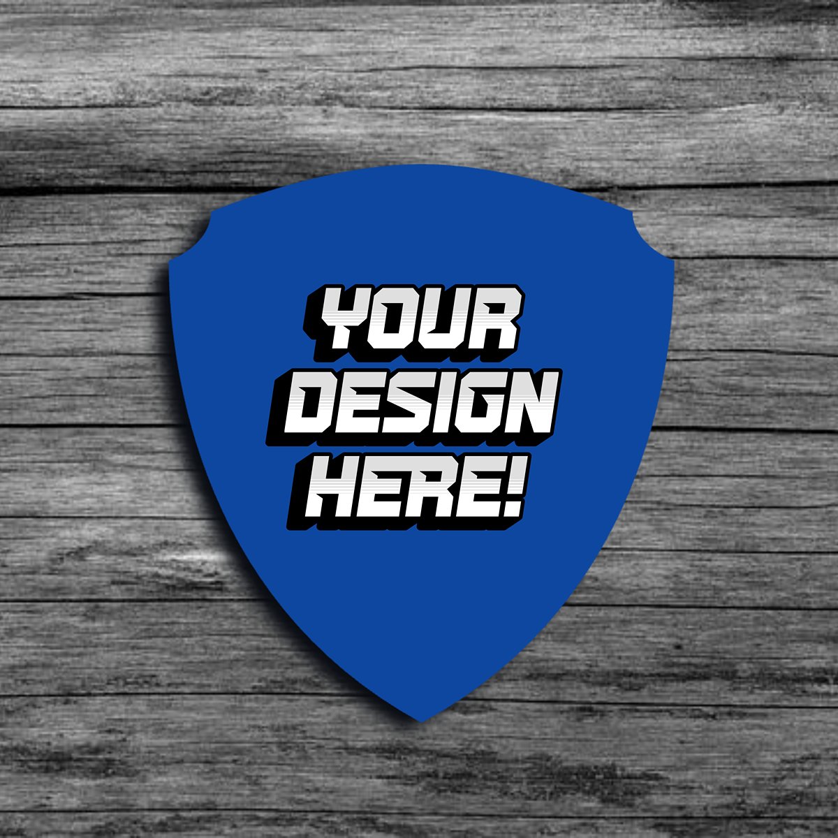 An image of a blue shield shaped template that says"Your Design Here!"