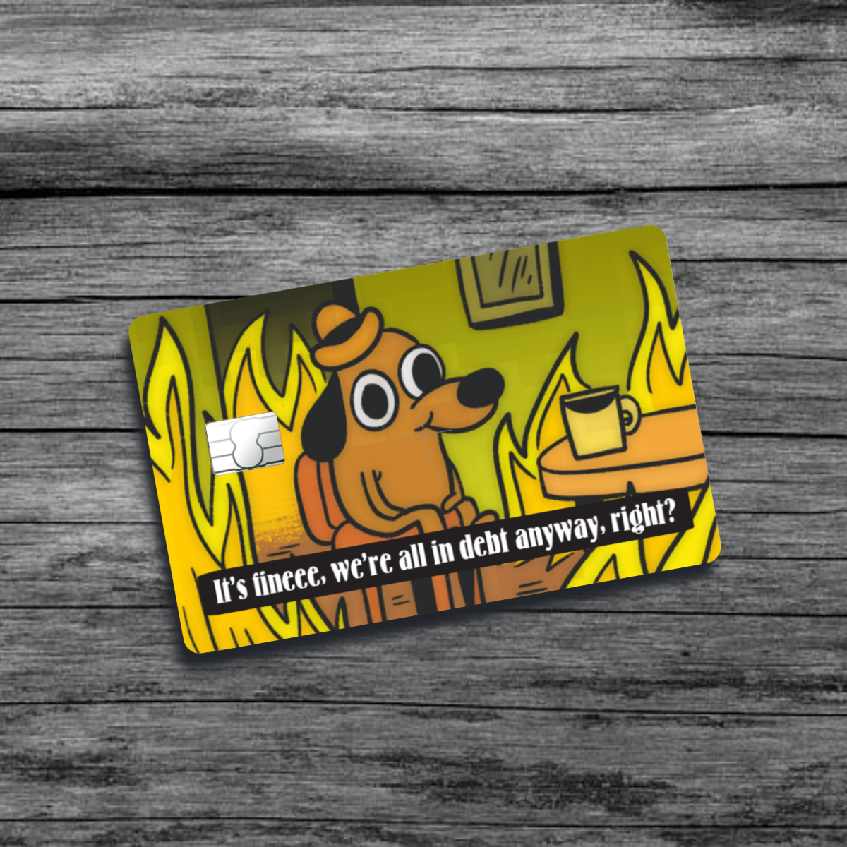 A credit card skin featuring the "This is fine" meme: a dog sitting calmly in a room engulfed in flames, sipping coffee, with a nonchalant expression.