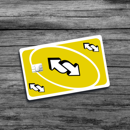 A credit card skin featuring the UNO reverse card: a bold design with the classic yellow background and a prominent white arrow symbol.