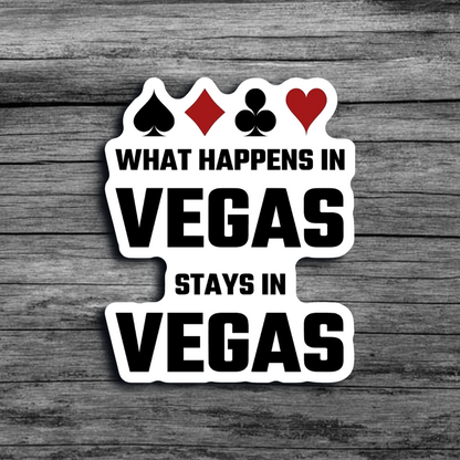 A white sticker with black font that says "What Happens in Vegas Stays in Vegas", with the four standard card suits' icons at the top