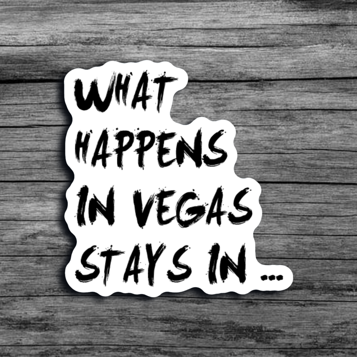 A white sticker with black font that says "What Happens in Vegas Stays In..."