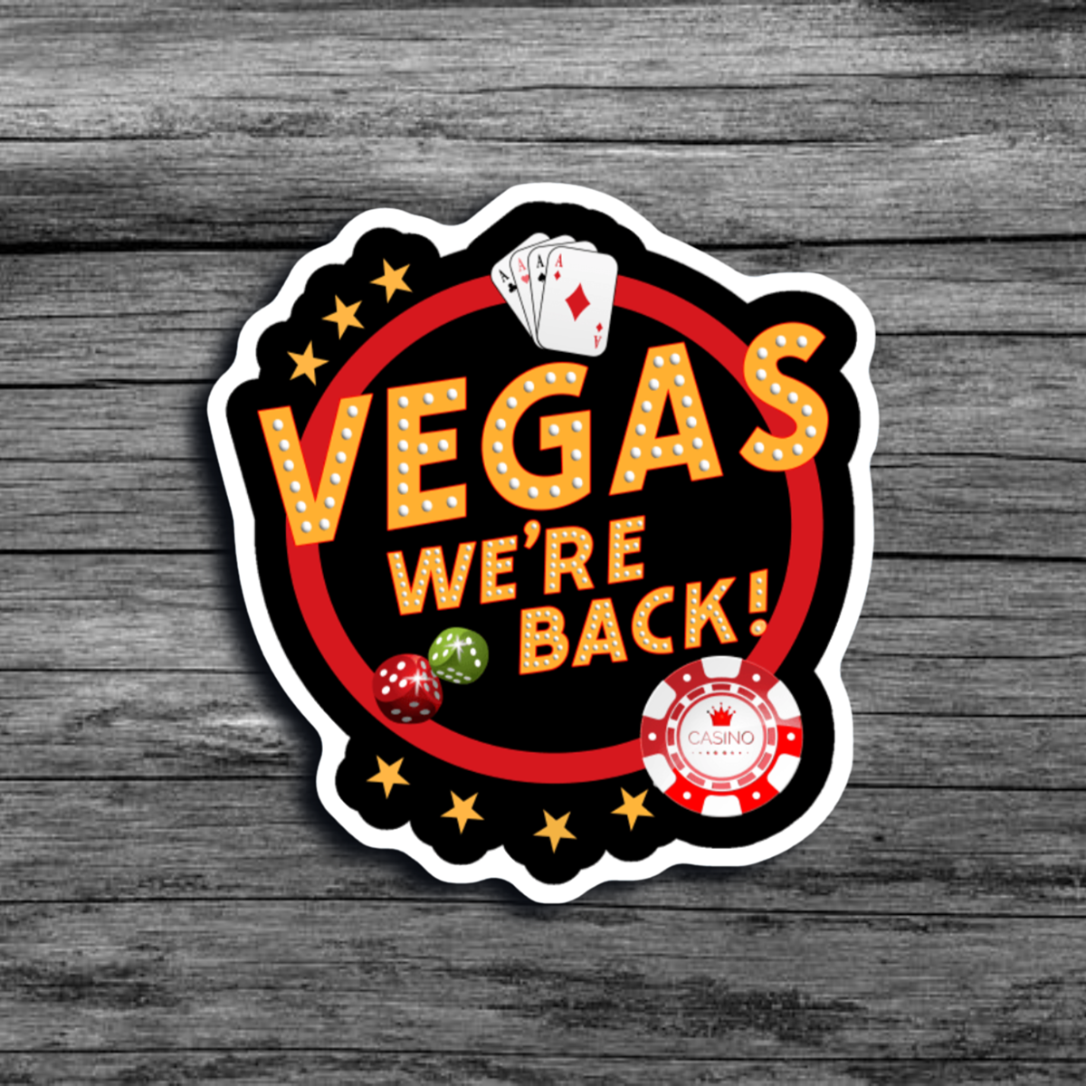 A sticker of a sign saying "Vegas We're Back!" with a casino chip, four Aces, and two rolling dice