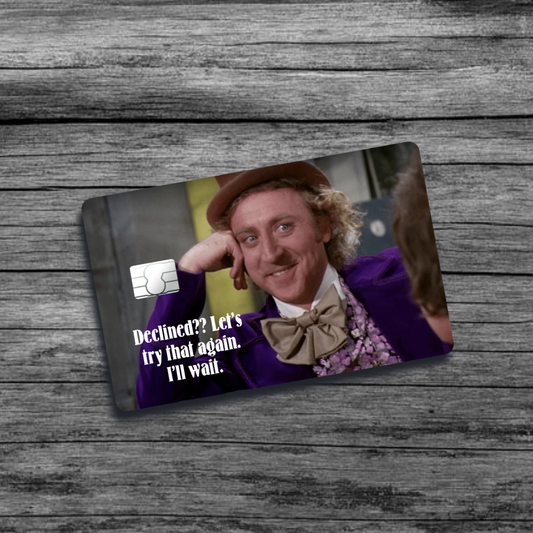 A credit card skin featuring the Willy Wonka meme: a grinning Willy Wonka resting his chin on his hand, with a playful, sarcastic expression.