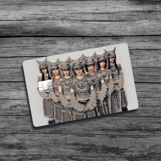 A credit card skin featuring K-Pop group XG, seven women with wolf-like, furry, tribal clothing and hats, standing in an offsetting triangular pattern.